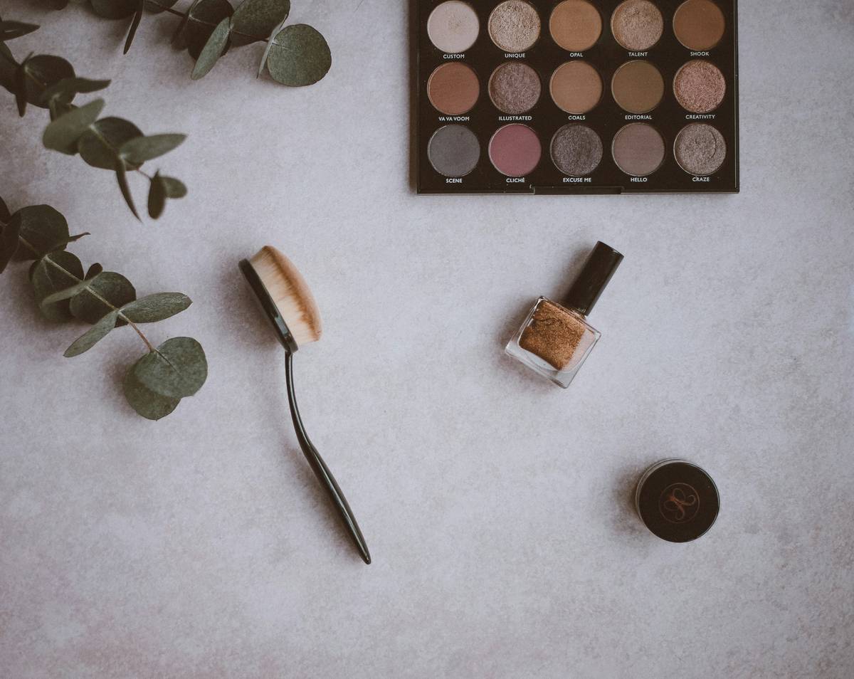 premium makeup foundation bottle beside flawless skin swatch on hand
